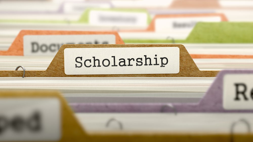 File Folder Labeled as Scholarship in Multicolor Archive. Closeup View. Blurred Image.